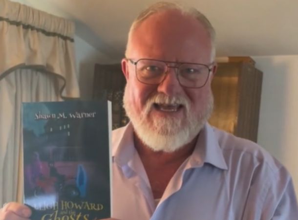 Shawn Warner shows off his novel, now a best seller!