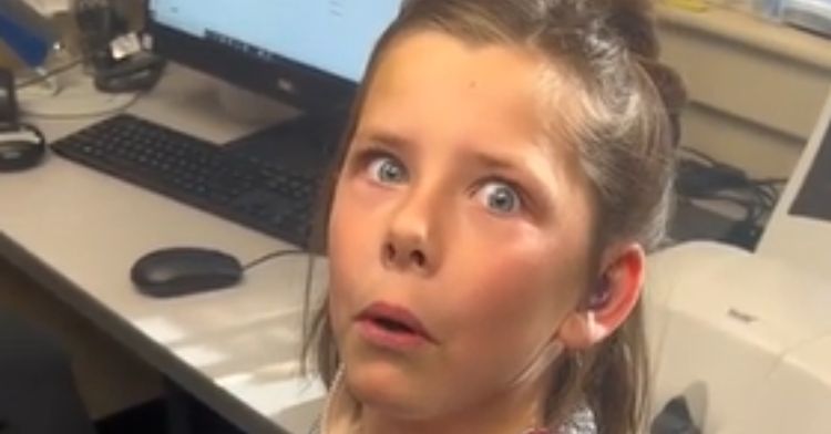 A little girl is surprised to hear her own voice.