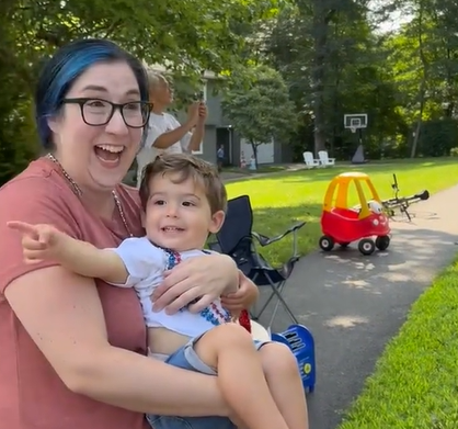 Colby is excited to see so many mail trucks on his block. 