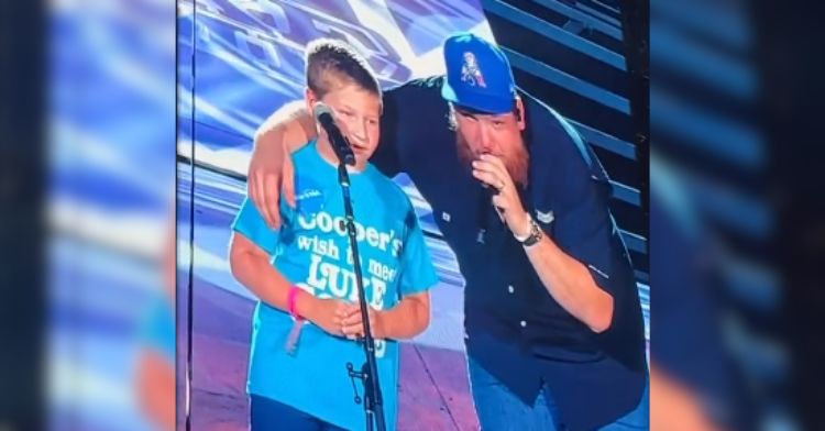 Luke Combs shares the stage with a young fan who beat cancer.