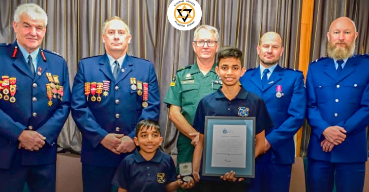 A teen and his younger brother smile as they pose for a photo with four adults. The teen is being honored for saving his brother’s life.