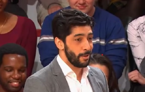 Image shows a French comedian assisting with a laughter experiment on a French talk show.