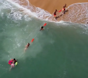 The lifeguards formed a human chain to pull the swimmer to shore.