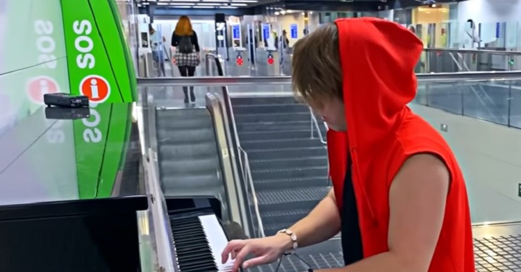 A pianist performing in a public metro station in Barcelona, Spain.