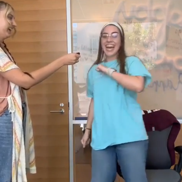 Teenager smiling and showing off her math dance moves.