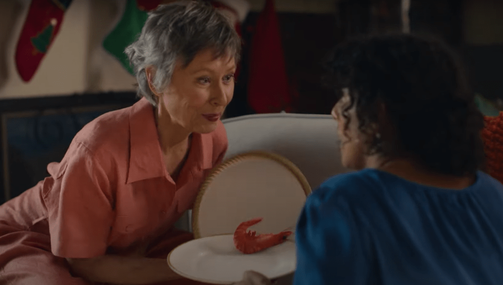 Grandma holds plate with shrimp.