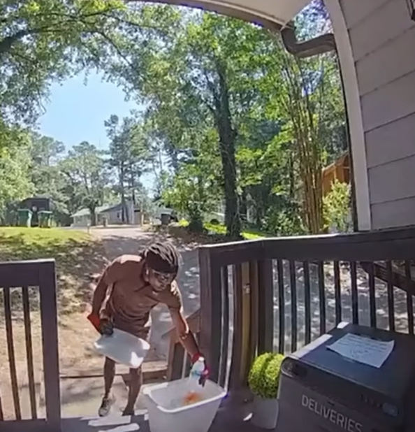 UPS delivery person picking up snacks and water from the porch.