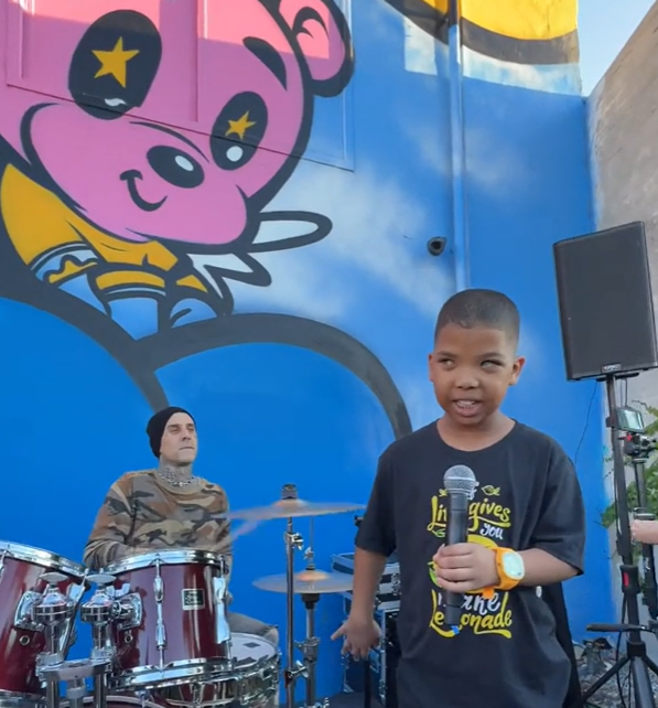 Blind 9-year-old Grayson singing while Travis Barker plays the drums.