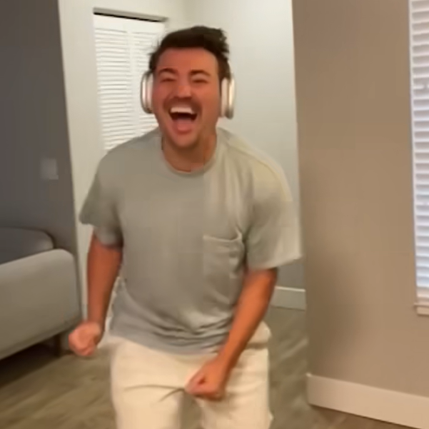 Man jumping for joy after unwrapping his birthday gift.