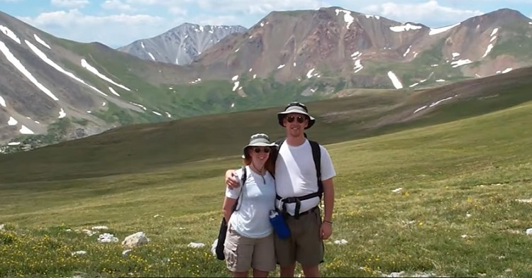 A couple, in love, posing in front of the Rockie Mountains in Colorado.