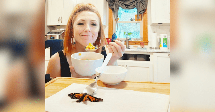 Butterfly joins woman for breakfast.