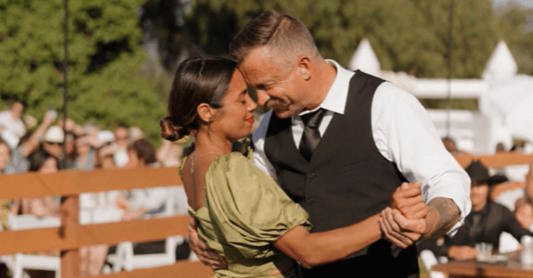 couple embracing during first dance at daughter's wedding.