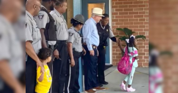 A little girl was escorted to school by police.