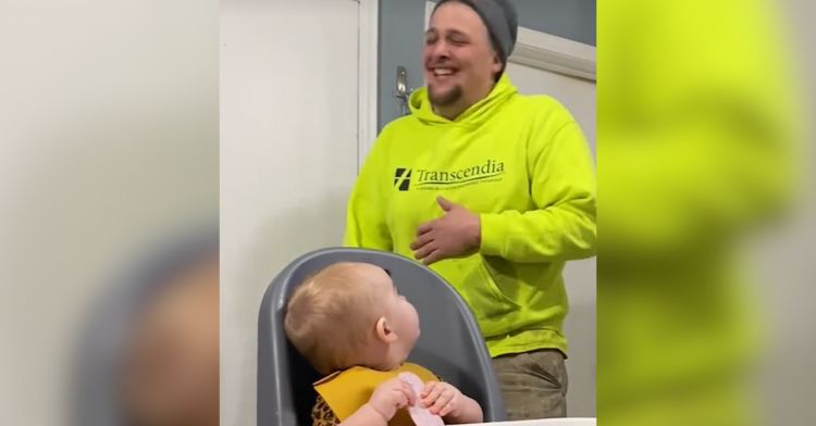 This baby couldn't understand why Dad was laughing.