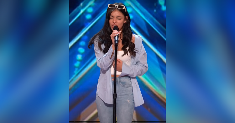 girl singing with blue background