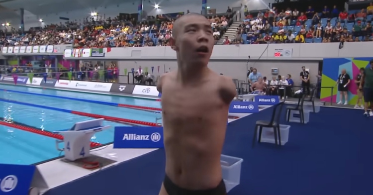 Armless swimmer Guo Jincheng walks away from the World Para Swimming Championships pool after competing in the men's S5 50m freestyle.