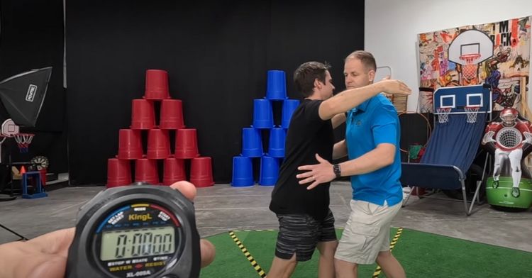 Two men try for the most hugs in one minute.