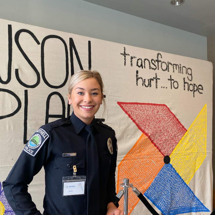Ivy smiles as she wears her police uniform.