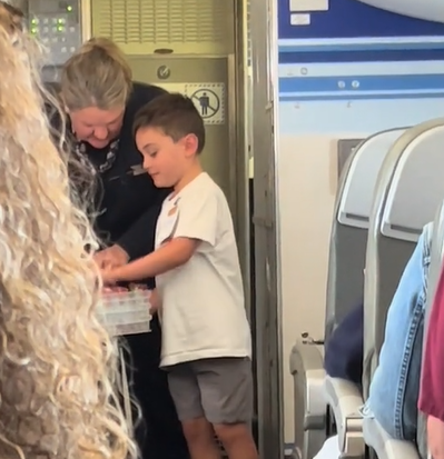 kid hands out candy in airplane