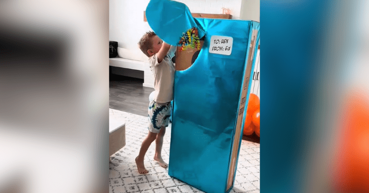 kid unwraps big blue box