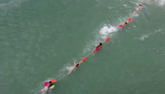 A team of lifeguards rescued a boogie boarder in the water.
