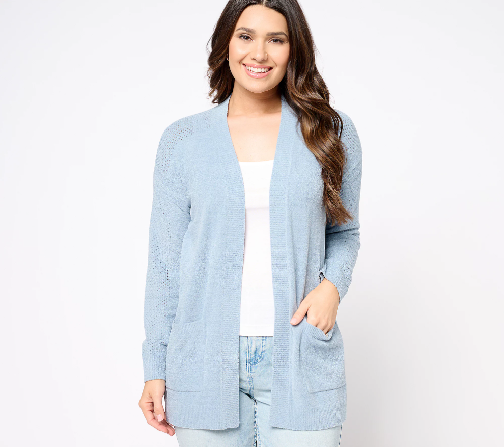 A woman smiles as she wears a Barefoot Dreams CozyChic Ultra Lite Pointelle Frame Cardigan.