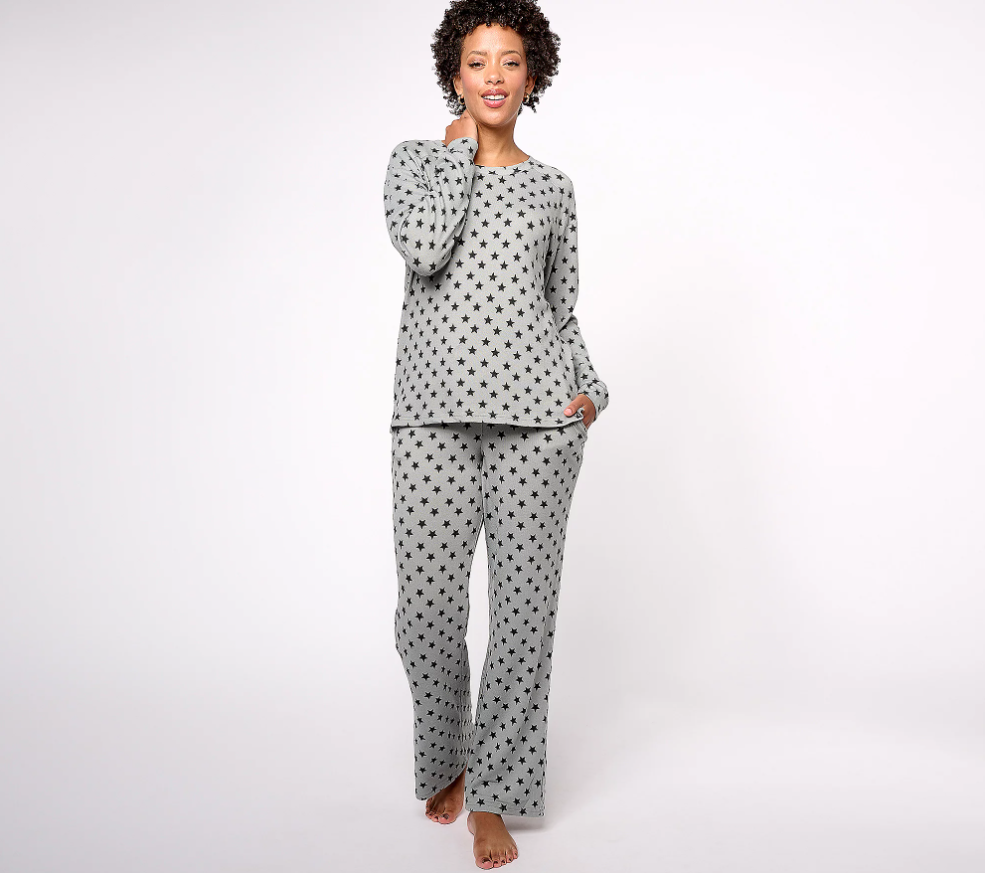 A woman smiles as she wears a MUK LUKS Lifewear Essentials Butter Knit Lounge Set.