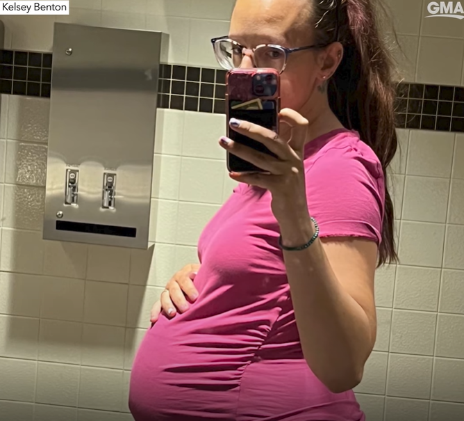 Kelsey Benton takes a mirror selfie, showing off her visibly pregnant stomach.