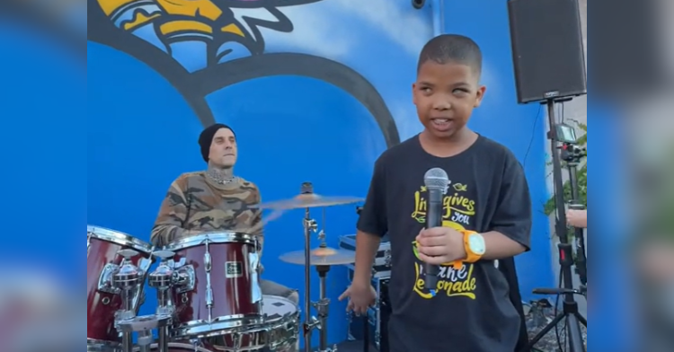 Travis Barker plays the drums with Grayson Roberts.