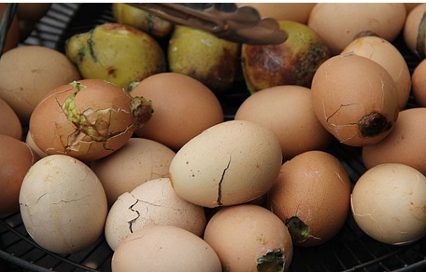 Image shows several boiled eggs, in the partially cracked shells, know as Balut, a Philippine delicacy.