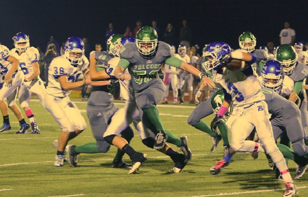 Image shows two high school football teams in play.