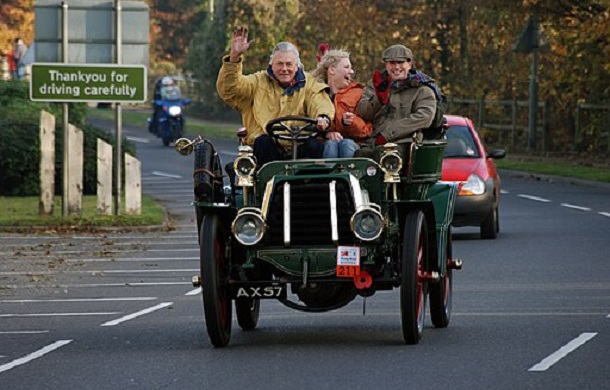 Image shows three people riding in an old car, waving, smiling, and enjoying the day. Gratitude abounds.