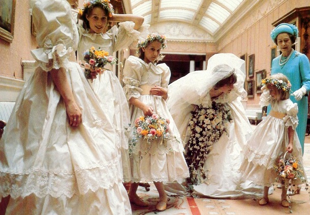 Princess Diana whispering encouraging words to a nervous flower girl.