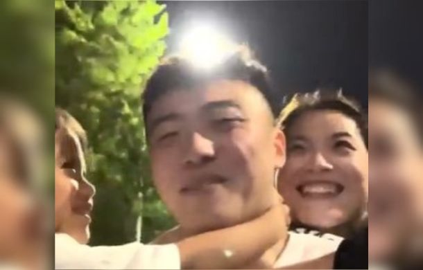 This is the way a man shows his family that he loves them. The image shows a family in Shandong, China, taking a walk. The man is carrying his wife on his back and his young daughter in front. They are all laughing and enjoying the evening.