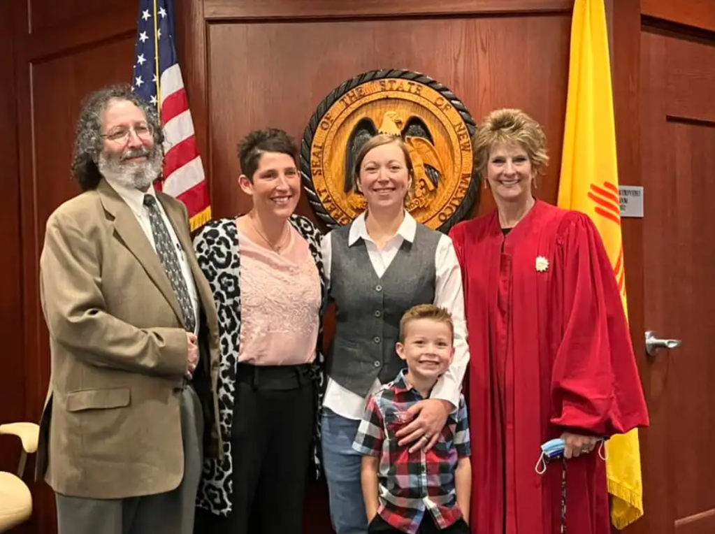 Jennifer and Kimberly Hubby smile and pose with their 5-year-old, Cameron, with two others after he was officially adopted by Jennifer.