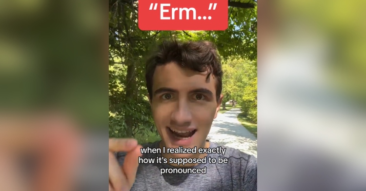 A man talks while walking in a wooded area. The word "Erm..." is on screen along with the words "... when I realized exactly how it's supposed to be pronounced."