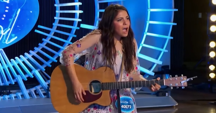Woman named Carly Moffa sings on "American Idol" and she plays the guitar.