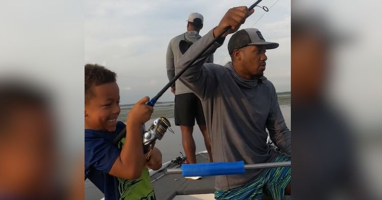 A sweet moment during a father-son fishing trip.