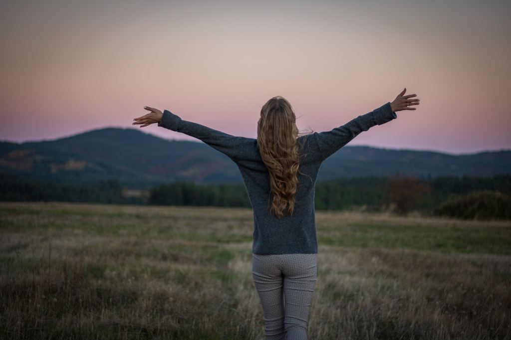 A woman finds inspiration in the open sky. 