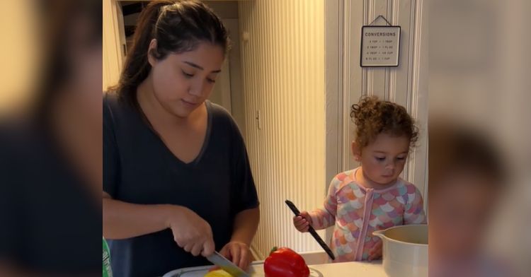 A little girl loses the pepper she's playing with.
