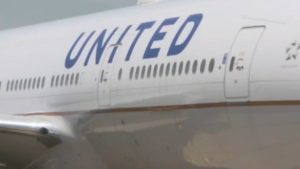 View of the side of an airplane that says "UNITED" on the side.