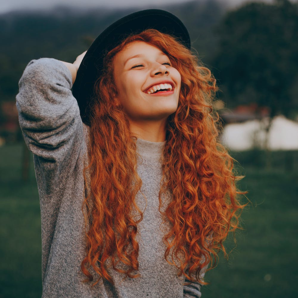 A woman smiling at the sky