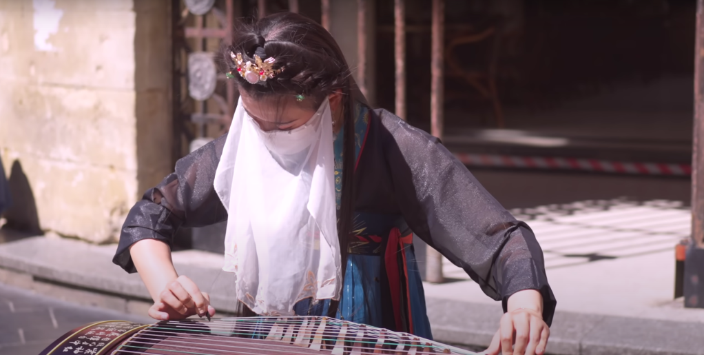 musician performing on a gu zheng