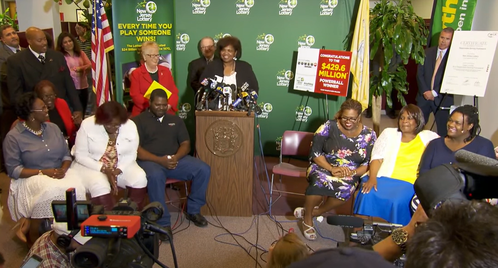 Perlie Mae Smith's family sit around at a press conference after winning the lottery.