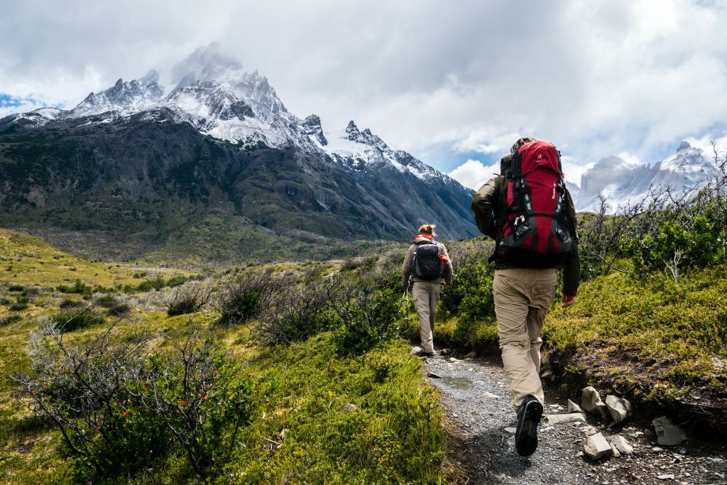 Hikers trek through the mountains to reach their destination. 