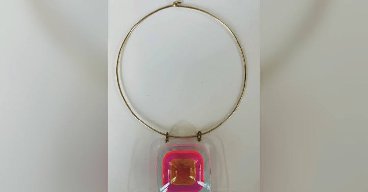 multicolored necklace on gold collar