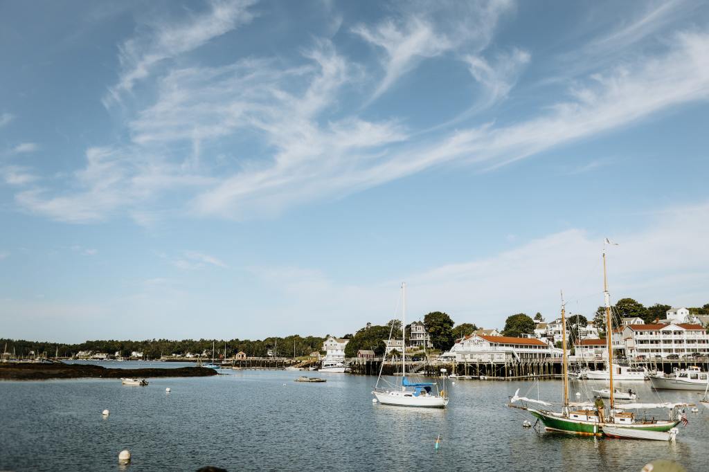 View of a large harbor in Maine. The sky is a bright blue with just a few wispy clouds.