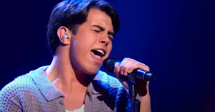 18-year-old Robbie Hunt sings passionately into the mic with his eyes closed while performing "Blue Suede Shoes" by Elvis Presley on "The Voice Australia."