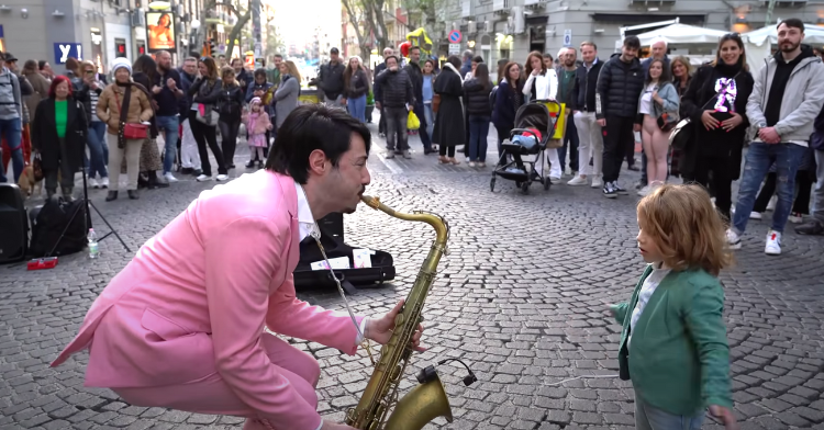 man in pink suit playing the saxophone