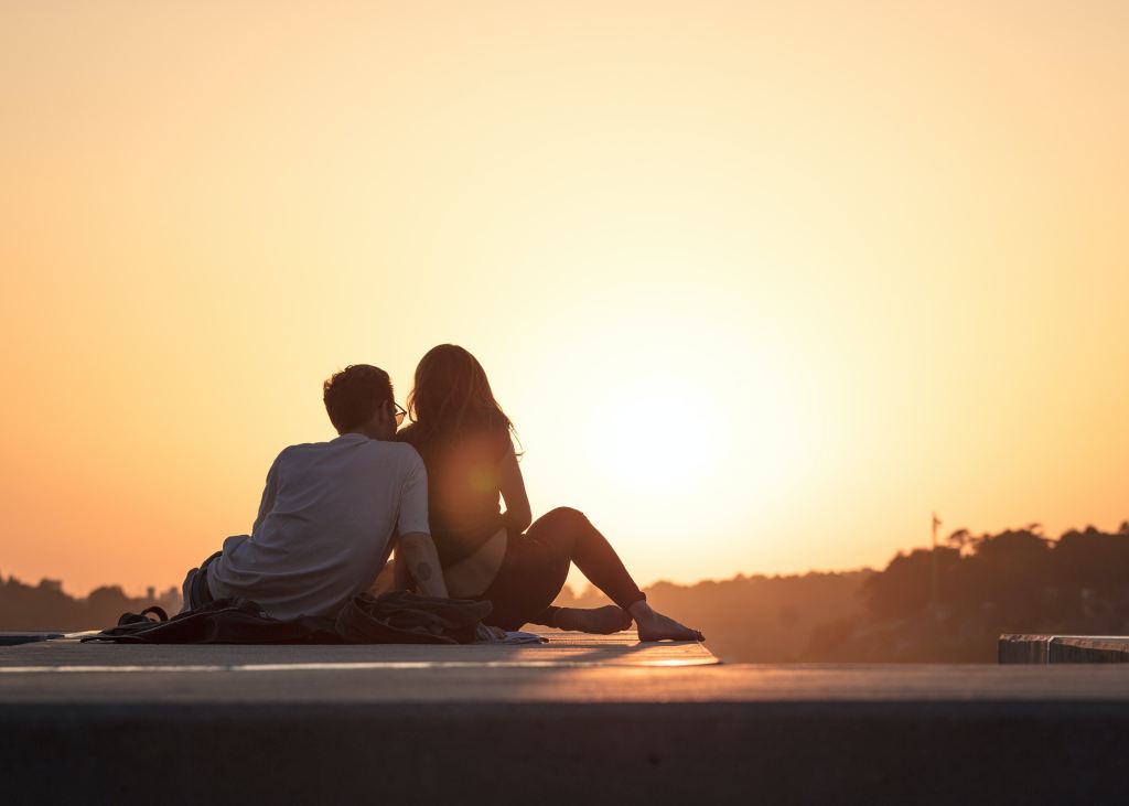 A couple enjoys a beautiful sunset together.